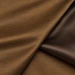 Close-up of copper-brown Dupion silk folded back to reveal the textured slubbed right side beside its smoother, darker satin reverse.