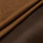Two folds of copper-brown Dupion silk showing the slubbed, lightly reflective right side and contrasting smooth dark-brown reverse.
