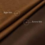 Folds of copper-brown Dupion silk with labels marking the slubbed right side and the smooth, darker reverse side.