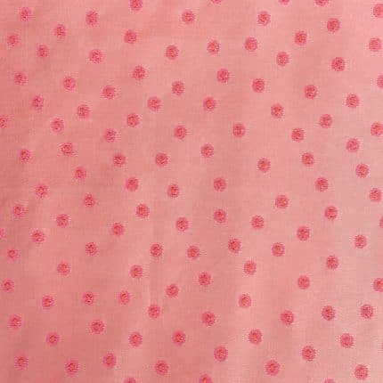 Flat view of soft pink silk jacquard with evenly spaced brighter pink circular motifs, each with a small golden-toned centre, across a fine, subtly lustrous woven ground.