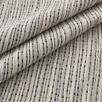 Close-up of off-white and midnight blue textured fabric laid in broad diagonal folds, revealing the repeated linear pattern of raised pale threads and narrow dark stripes.