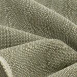 Folded edge of textured sage green, ivory and beige linen fabric, showing a pale woven selvedge and the thick, interlaced threads on the main surface.